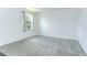 Bedroom featuring neutral carpet, white walls, and a large window at 12905 Brookside Moss Dr, Riverview, FL 33579