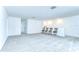 Spacious bonus room featuring neutral carpet, white walls, and bar seating area at 12905 Brookside Moss Dr, Riverview, FL 33579