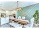 Elegant dining area with a rustic table, stylish chairs and decorative wall accents at 12905 Brookside Moss Dr, Riverview, FL 33579