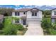 Charming two-story home featuring a well-manicured lawn and attached two car garage at 12905 Brookside Moss Dr, Riverview, FL 33579