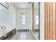 Bright foyer featuring wood-look flooring, a stylish mirror, and a decorative bench at 12905 Brookside Moss Dr, Riverview, FL 33579