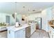 Open kitchen with island, stainless steel appliances and decorative lighting fixtures at 12905 Brookside Moss Dr, Riverview, FL 33579