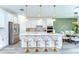Bright kitchen with white cabinets, quartz countertops, and stainless steel appliances at 12905 Brookside Moss Dr, Riverview, FL 33579