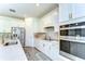Modern kitchen featuring stainless steel appliances, quartz countertops, and a center island at 12905 Brookside Moss Dr, Riverview, FL 33579
