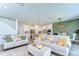 Open concept living room showcasing modern decor and seamless flow into the kitchen at 12905 Brookside Moss Dr, Riverview, FL 33579