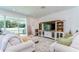 Bright living room featuring a decorative entertainment center and sliding glass doors to the backyard at 12905 Brookside Moss Dr, Riverview, FL 33579