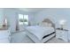 Serene main bedroom features a plush bed and a large window with natural light at 12905 Brookside Moss Dr, Riverview, FL 33579
