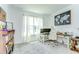 Home office with two desks, a large window, and a bookshelf at 12905 Brookside Moss Dr, Riverview, FL 33579