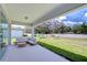 Covered patio with outdoor seating overlooking the backyard at 12905 Brookside Moss Dr, Riverview, FL 33579