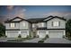 New construction exterior elevation showing 2-story townhome with attached garages and neutral paint scheme at 13084 Stillmont Pl, Tampa, FL 33624