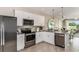 Stainless steel appliances, granite countertops, and bright lighting create a functional and modern kitchen space at 13084 Stillmont Pl, Tampa, FL 33624