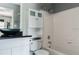 Bathroom with a toilet, tub with white tiling, and vanity with vessel sink at 1400 Gandy N Blvd # 708, St Petersburg, FL 33702