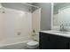 Bathroom featuring a shower and bath tub combo, a new vanity, and a dark gray wall at 1400 Gandy N Blvd # 708, St Petersburg, FL 33702