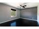 Bedroom with dark wood floors, ceiling fan, and unique wallpaper at 1400 Gandy N Blvd # 708, St Petersburg, FL 33702