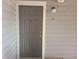 The front door to the property is a solid, painted panel door with white trim at 1400 Gandy N Blvd # 708, St Petersburg, FL 33702