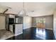 Open living area with black appliances, tile and dark wood floors, and sliding glass doors at 1400 Gandy N Blvd # 708, St Petersburg, FL 33702