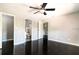 Light-filled main bedroom with dark wood floors, ceiling fan, and closet at 1400 Gandy N Blvd # 708, St Petersburg, FL 33702
