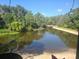 A serene pond view, framed by lush greenery and a fountain at 1400 Gandy N Blvd # 708, St Petersburg, FL 33702