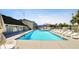 Community swimming pool with lounge chairs, shade, and a view of the surrounding buildings at 1400 Gandy N Blvd # 708, St Petersburg, FL 33702