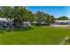 Well-manicured lawn with lush trees in a quiet residential community at 1542 Rebecca Ln, Dunedin, FL 34698