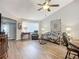 Bright living room boasting a ceiling fan, decorative art and comfortable seating at 1542 Rebecca Ln, Dunedin, FL 34698