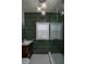 Bathroom with glass shower, unique tiling, and stylish vanity with globe lighting at 1606 S Arrawana Ave, Tampa, FL 33629