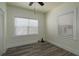 Bright bedroom featuring wood-look floors, fresh paint, and new blinds at 1606 S Arrawana Ave, Tampa, FL 33629