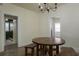 Dining area featuring a round wood table with bench seating and a chandelier at 1606 S Arrawana Ave, Tampa, FL 33629