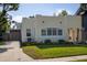 Charming home featuring an arched entryway, well-manicured lawn, and a driveway at 1606 S Arrawana Ave, Tampa, FL 33629