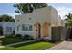 Charming home showcasing a well-manicured lawn and unique architectural details, including arched entryways at 1606 S Arrawana Ave, Tampa, FL 33629