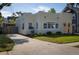 Charming single-Gathering home featuring a well-manicured lawn, an inviting arched doorway, and a concrete driveway at 1606 S Arrawana Ave, Tampa, FL 33629