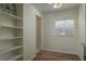 Hallway featuring built-in shelves and wood-look floors at 1606 S Arrawana Ave, Tampa, FL 33629