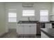 Bright kitchen featuring stainless steel appliances, modern countertops, and a view to an adjoining room at 1606 S Arrawana Ave, Tampa, FL 33629
