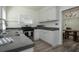 Kitchen with white cabinets, stainless steel appliances and dark gray countertops at 1606 S Arrawana Ave, Tampa, FL 33629