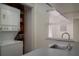 The kitchenette features a sink, stacked washer and dryer, and a bright window at 1606 S Arrawana Ave, Tampa, FL 33629