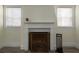 Cozy fireplace with mantle is the focal point of a living area featuring wood-look floors and neutral colors at 1606 S Arrawana Ave, Tampa, FL 33629