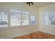 Bright living room featuring charming tile floors and two large windows with white shutters at 1606 S Arrawana Ave, Tampa, FL 33629