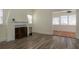 Living area featuring wood-look floors, a decorative fireplace, and an archway leading to another room at 1606 S Arrawana Ave, Tampa, FL 33629
