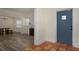 Open-concept living space with wood-look floors, a fireplace, and an archway leading to a tiled entrance at 1606 S Arrawana Ave, Tampa, FL 33629