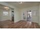 Open-concept living room leading to the patio, with wood-look floors at 1606 S Arrawana Ave, Tampa, FL 33629
