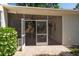 Inviting screened-in patio with outdoor seating, ceiling fans, and an open view of the lush greenery at 1606 S Arrawana Ave, Tampa, FL 33629