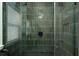 Modern bathroom shower featuring stylish green vertical tiles, glass enclosure, and matte black hardware at 1606 S Arrawana Ave, Tampa, FL 33629