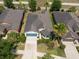 Aerial view of a charming single-Gathering home with a manicured lawn and a two car garage at 16313 Treasure Point Dr, Wimauma, FL 33598
