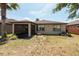 Spacious backyard with a covered lanai, lush greenery, and a serene outdoor space at 16313 Treasure Point Dr, Wimauma, FL 33598
