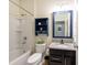 Bathroom with granite countertops, blue vanity, and shower-tub combination at 16313 Treasure Point Dr, Wimauma, FL 33598
