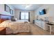Bedroom featuring a queen size bed, wood laminate flooring, and contemporary furnishings at 16313 Treasure Point Dr, Wimauma, FL 33598