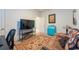 Relaxing bedroom with comfortable seating, bright natural light, and TV at 16313 Treasure Point Dr, Wimauma, FL 33598