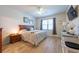 Comfortable bedroom with a wooden bed frame, neutral decor, and a window providing natural light at 16313 Treasure Point Dr, Wimauma, FL 33598