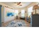 Bright bedroom featuring hardwood floors, many windows, and colorful decor at 16313 Treasure Point Dr, Wimauma, FL 33598
