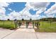 Community fenced dog park offering separate small and large dog areas with benches for owners at 16313 Treasure Point Dr, Wimauma, FL 33598